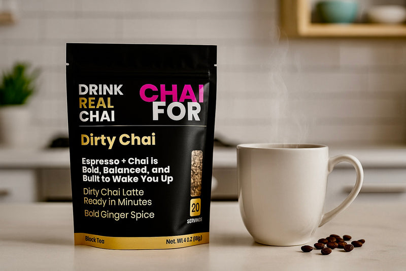 Packaging of Dirty Chai tea with a white mug and coffee beans on a kitchen counter.