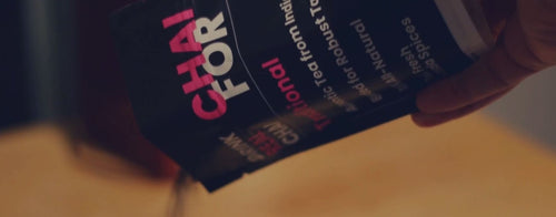 Still image of traditional chai tea being poured to make chai tea